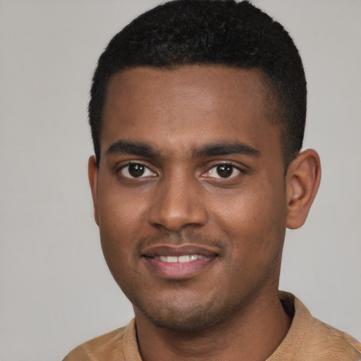 Joyful black young-adult male with short  black hair and brown eyes