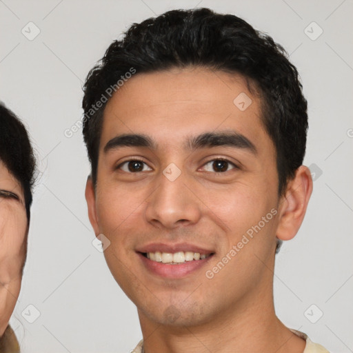 Joyful white young-adult male with short  black hair and brown eyes