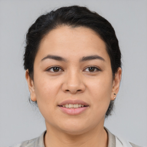 Joyful latino young-adult female with medium  brown hair and brown eyes