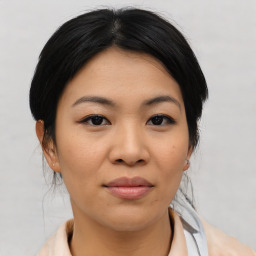 Joyful asian young-adult female with medium  black hair and brown eyes