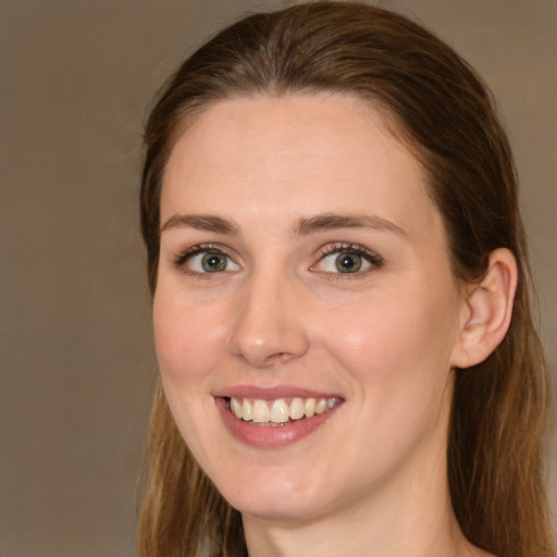 Joyful white young-adult female with medium  brown hair and green eyes