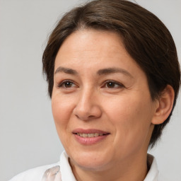 Joyful white adult female with medium  brown hair and brown eyes