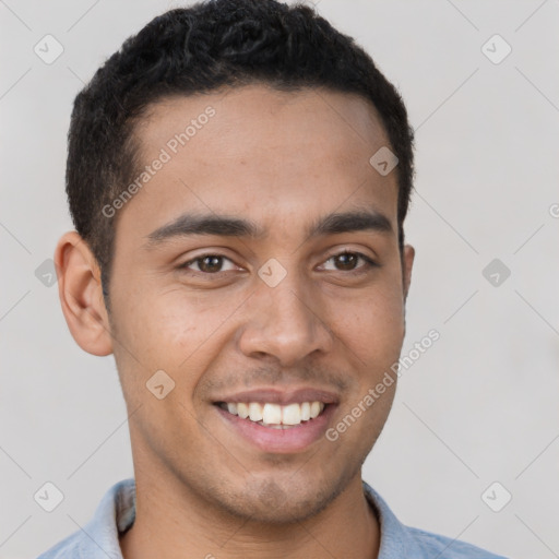 Joyful latino young-adult male with short  brown hair and brown eyes