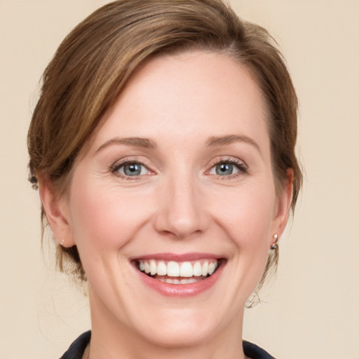 Joyful white young-adult female with medium  brown hair and blue eyes