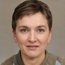 Joyful white adult female with short  brown hair and grey eyes