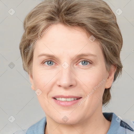 Joyful white adult female with medium  brown hair and blue eyes