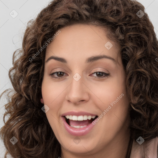 Joyful white young-adult female with long  brown hair and brown eyes