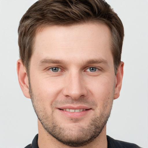 Joyful white young-adult male with short  brown hair and grey eyes