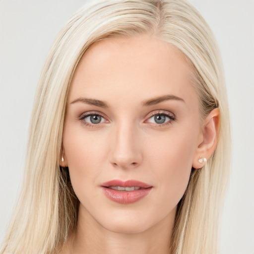 Joyful white young-adult female with long  brown hair and blue eyes