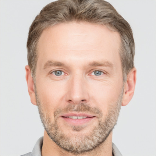 Joyful white adult male with short  brown hair and grey eyes