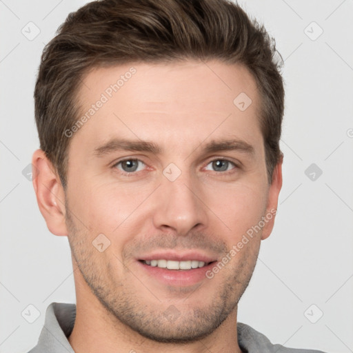 Joyful white young-adult male with short  brown hair and grey eyes