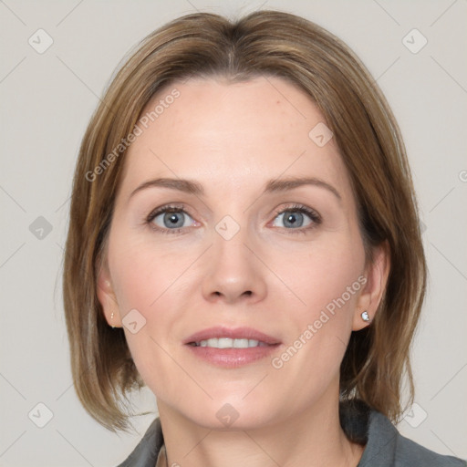 Joyful white adult female with medium  brown hair and blue eyes