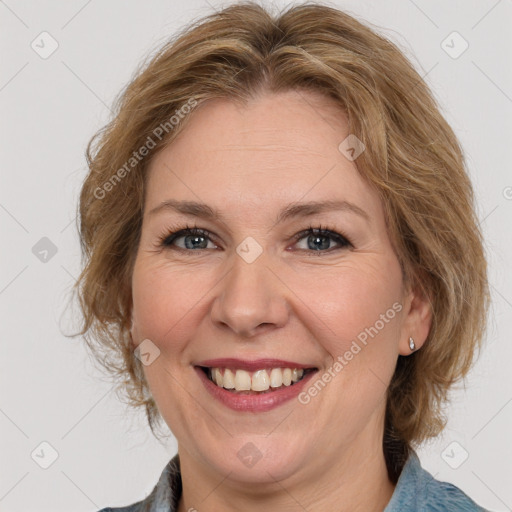 Joyful white adult female with medium  brown hair and blue eyes