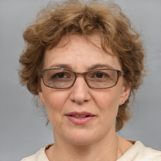 Joyful white middle-aged female with medium  brown hair and blue eyes