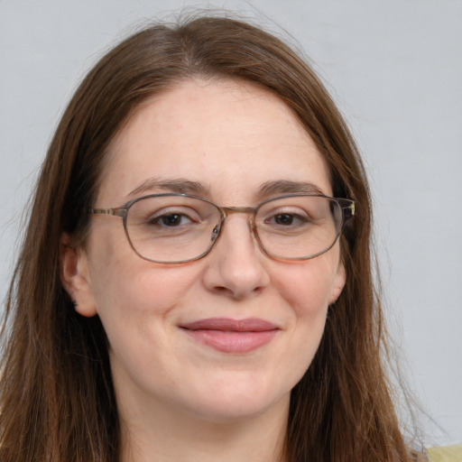 Joyful white adult female with long  brown hair and grey eyes