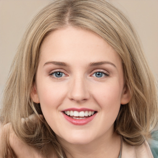 Joyful white young-adult female with medium  brown hair and blue eyes