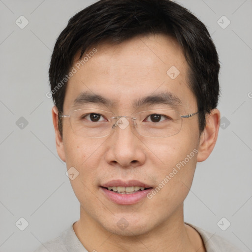 Joyful asian young-adult male with short  brown hair and brown eyes