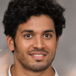 Joyful latino young-adult male with short  brown hair and brown eyes