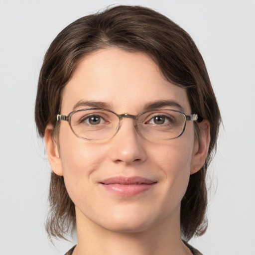 Joyful white young-adult female with medium  brown hair and grey eyes