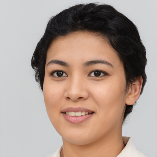Joyful asian young-adult female with short  black hair and brown eyes