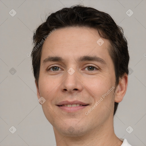 Joyful white adult male with short  brown hair and brown eyes