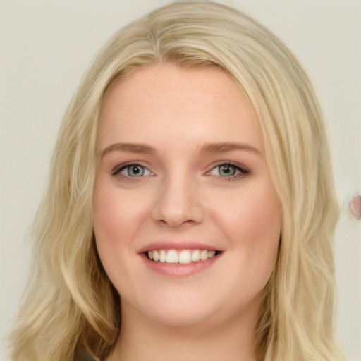 Joyful white young-adult female with long  brown hair and blue eyes