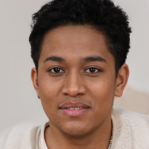 Joyful black young-adult male with short  black hair and brown eyes