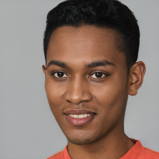 Joyful black young-adult male with short  black hair and brown eyes