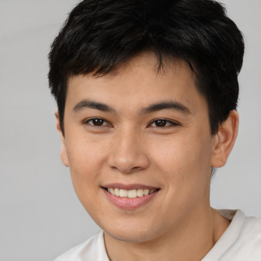 Joyful asian young-adult male with short  brown hair and brown eyes