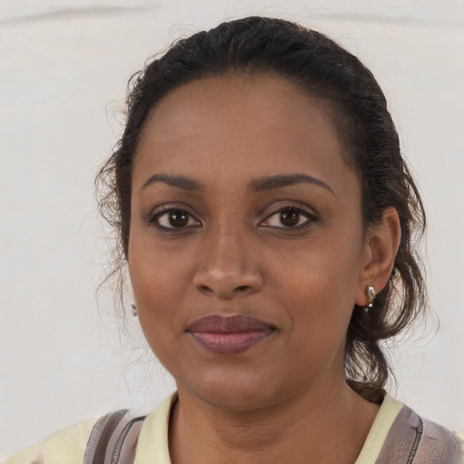 Joyful black young-adult female with medium  brown hair and brown eyes
