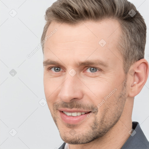 Joyful white adult male with short  brown hair and brown eyes