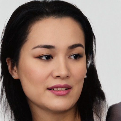 Joyful white young-adult female with long  black hair and brown eyes