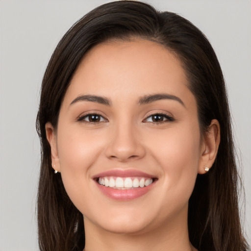 Joyful white young-adult female with long  brown hair and brown eyes