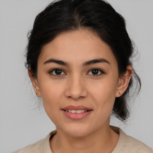 Joyful latino young-adult female with medium  brown hair and brown eyes