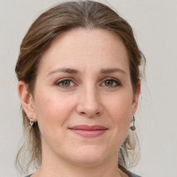 Joyful white adult female with medium  brown hair and grey eyes