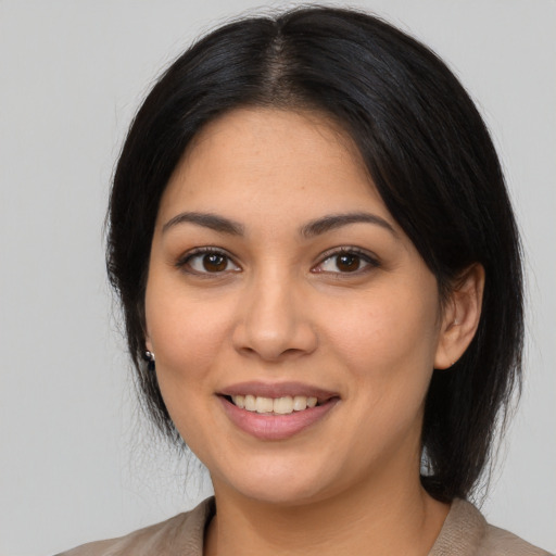 Joyful latino young-adult female with medium  black hair and brown eyes