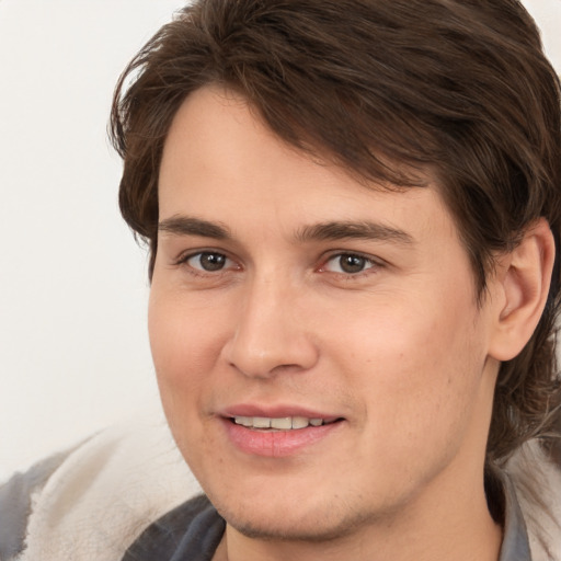 Joyful white young-adult male with medium  brown hair and brown eyes