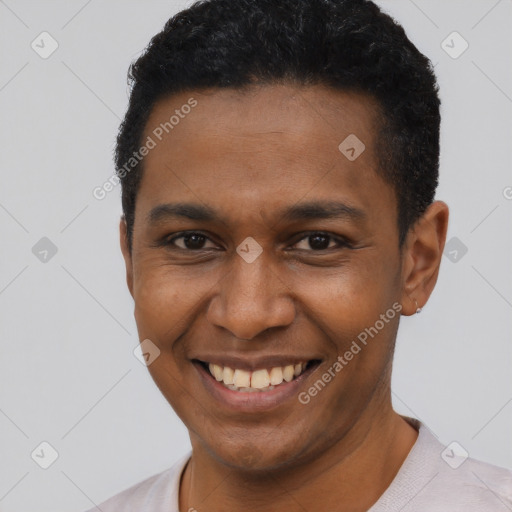 Joyful latino young-adult male with short  black hair and brown eyes