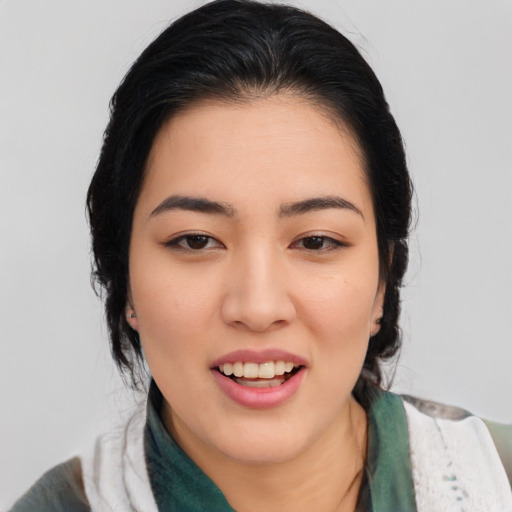 Joyful asian young-adult female with medium  black hair and brown eyes