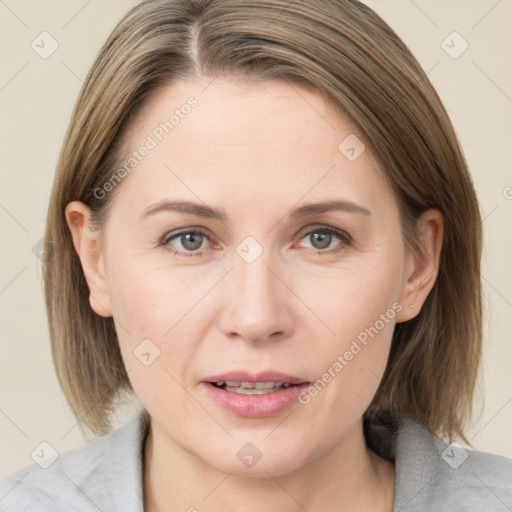 Joyful white adult female with medium  brown hair and grey eyes