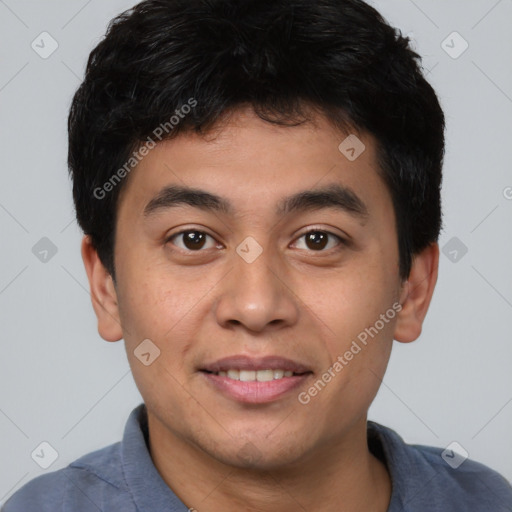 Joyful asian young-adult male with short  black hair and brown eyes