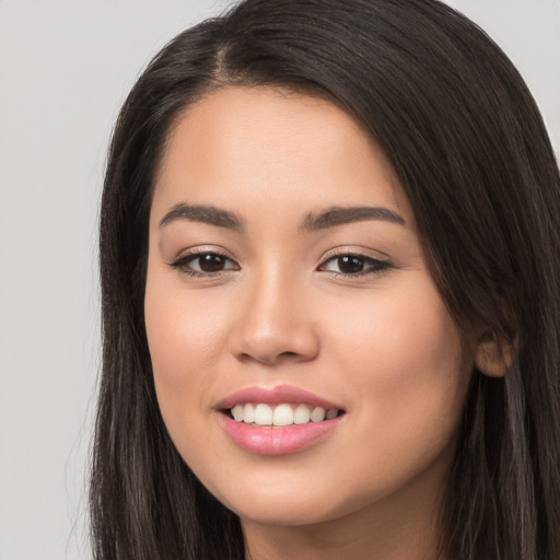 Joyful white young-adult female with long  brown hair and brown eyes