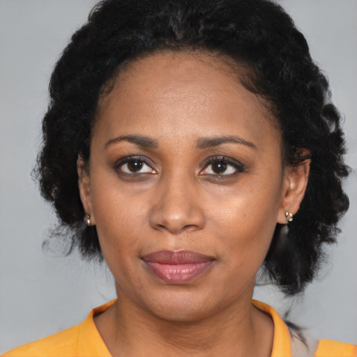 Joyful latino adult female with medium  black hair and brown eyes