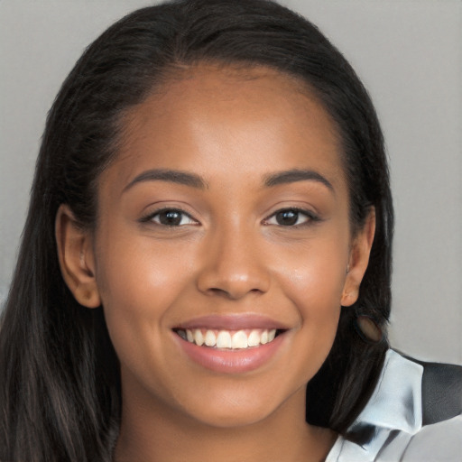 Joyful latino young-adult female with long  brown hair and brown eyes