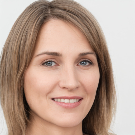 Joyful white young-adult female with long  brown hair and green eyes