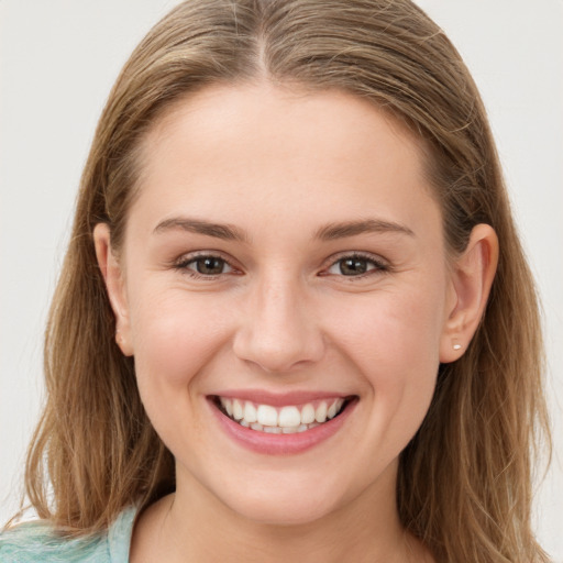 Joyful white young-adult female with long  brown hair and grey eyes