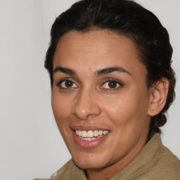 Joyful latino young-adult female with short  brown hair and brown eyes