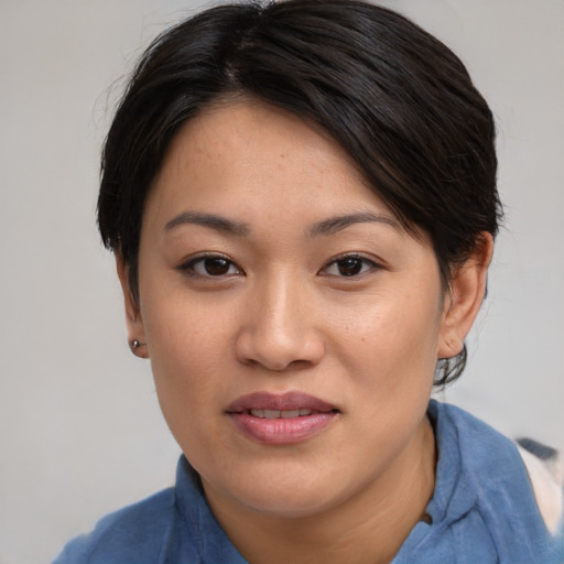 Joyful asian young-adult female with short  brown hair and brown eyes