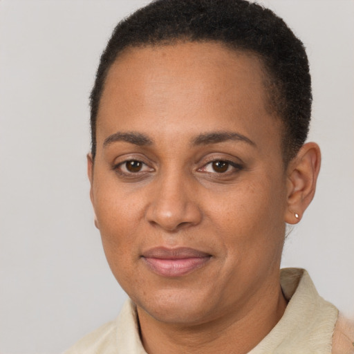 Joyful black adult female with short  brown hair and brown eyes