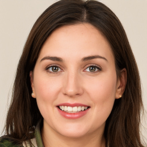 Joyful white young-adult female with long  brown hair and brown eyes